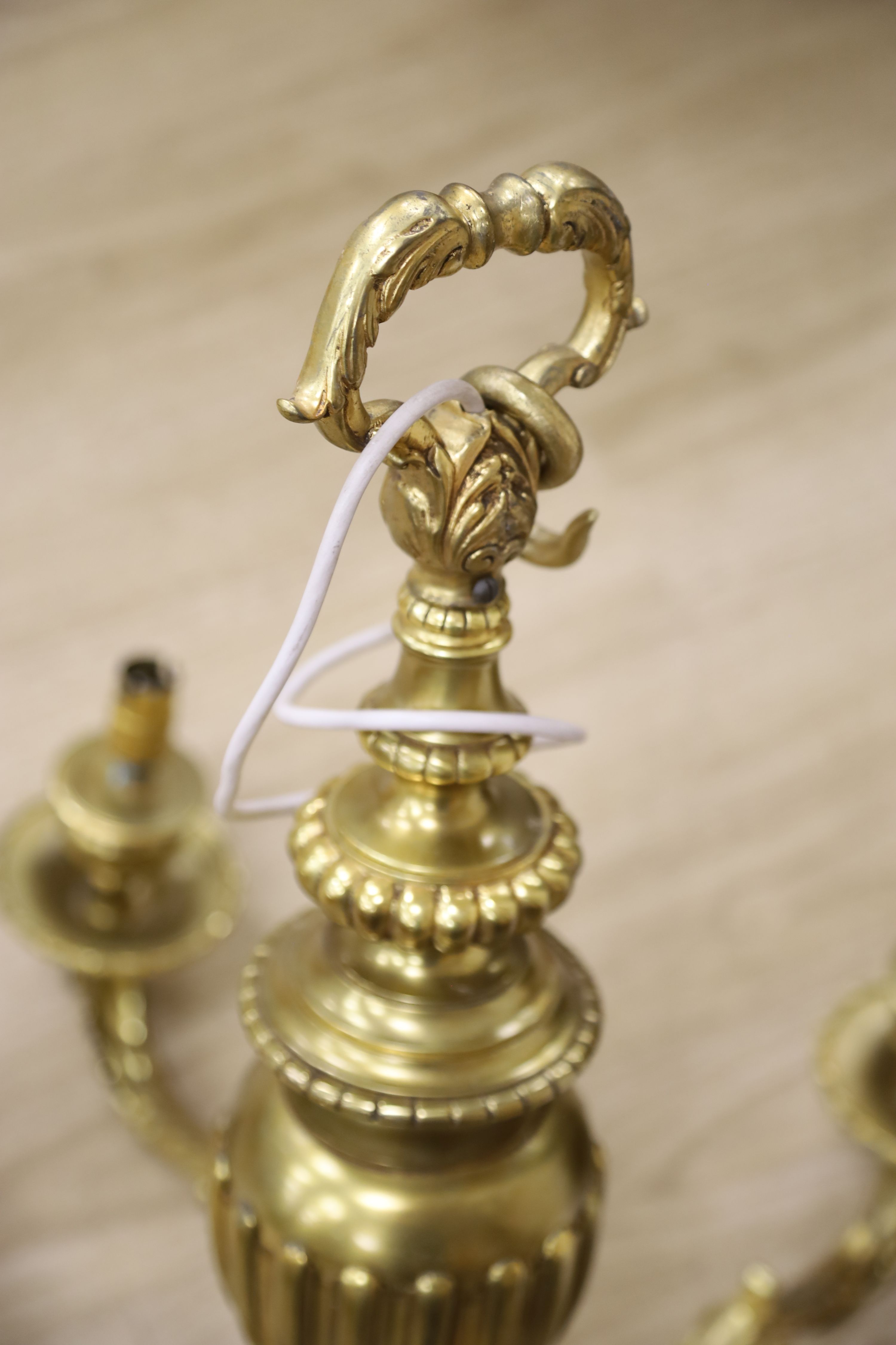 A Louis XIV style five branch solid brass chandelier, drop 65cm